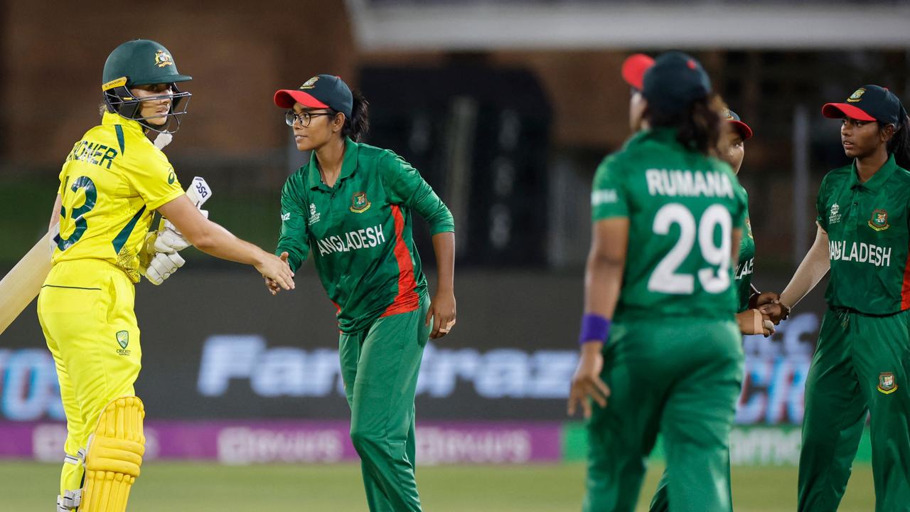 Australia's Ashleigh Gardner (L) is congratulated by Bangladesh players after Australia’s win. (Photo by Marco Longari / AFP)