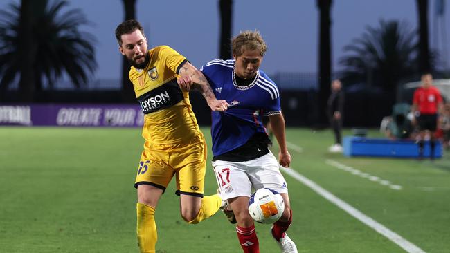 Central Coast defender Storm Roux (left) tries to halt the progress of Yokohama F. Marinos goalscorer Kenta Inoue in Gosford. Picture: Matt King/Getty Images