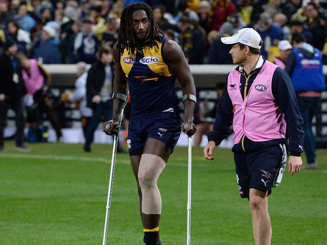 West Coast's Nic Naitanui leaves the field on crutches after Friday night’s win over Hawthorn at Subiaco Oval. Picture: Daniel Wilkins