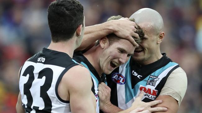 Kane Farrell, centre, celebrates with Darcy Byrne-Jones and Sam Powell-Pepper. Picture: Sarah Reed