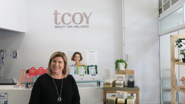 Karen Yates stands beside her front desk at TCOY Day Spa.