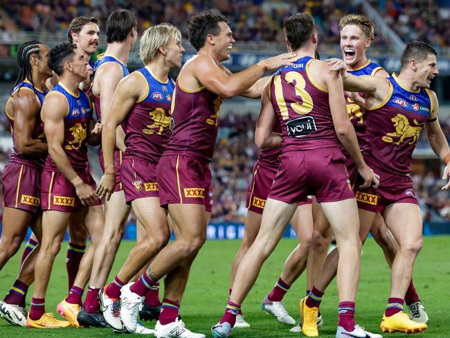 Brisbane teammates get around Logan Morris after he kicked his first AFL goal. Picture: Getty Images