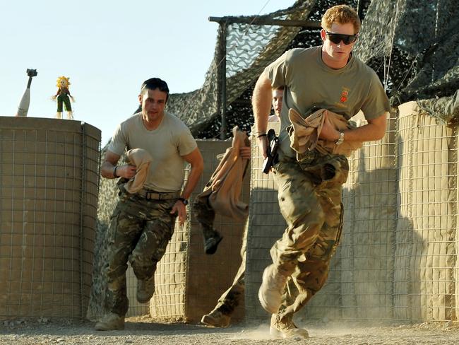 Prince Harry runs to his helicopter in Afghanistan in 2012. Picture: AFP