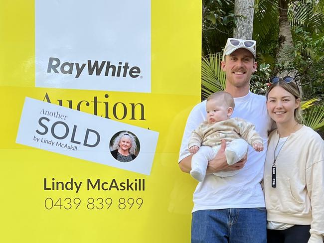 REAL ESTATE: Jordie Hansen and Sam Frost with baby, Ted, pose for a photo after buying a Doonan home at auction. Image supplied by Ray White.