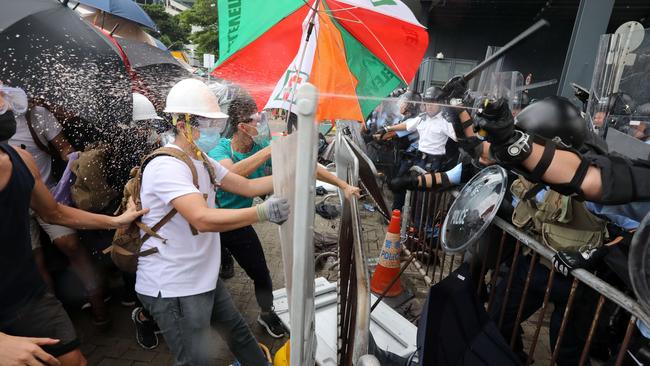 Police officers spray rioters. Picture: SCMP/Felix Wong