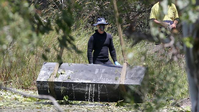 Police retrieve a large metal toolbox from a dam near Scrubby Creek, Kingston, four years ago.