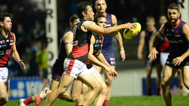 West Adelaide’s Kaine Stevens gets his kick away under pressure against Norwood. Picture: Michael Marschall.