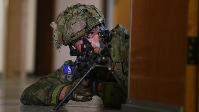 A soldier searches for mock targets in the military drill at the old RAH. Picture: Tait Schmaal