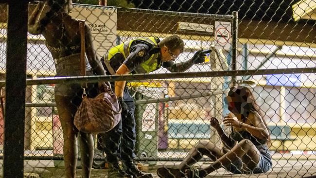 Police attend to a woman who was sprayed.