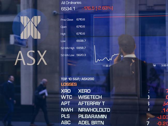 Pedestrians are reflected in a window with an indicator board displaying stock prices at the Australian Stock Exchange (ASX) in Sydney, Tuesday, August 6, 2019. (AAP Image/Steven Saphore) NO ARCHIVING