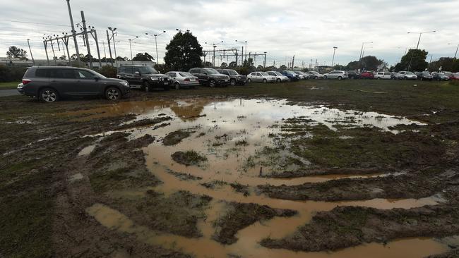 The vacant land used as a carpark near Cranbourne railway station resembles a waterlogged centre square at a suburban footy oval. Picture: Chris Eastman