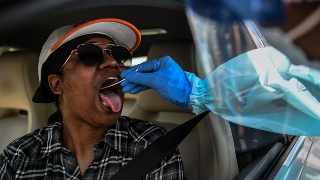 A medical personnel member takes samples at a ‘drive-thru’ coronavirus testing lab set up by a local community center in West Palm Beach, north of Miami. Picture: AFP