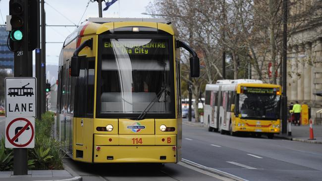 Public transport - tag up. Tram at intersection and bus at bus stop alongside the GPO in King William Street, Adelaide.