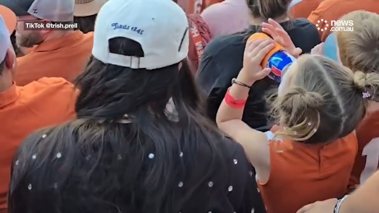 Young child filmed chugging beer at a football game