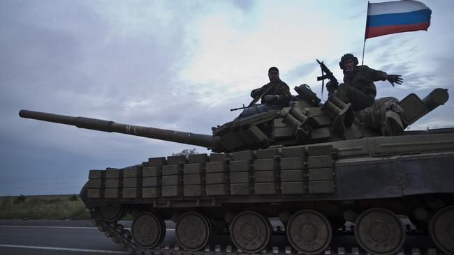 Tanks carrying Russian flags on the road from Donetsk to the Russian border, days after the MH17 crash in the area. Picture: Ella Pellegrini