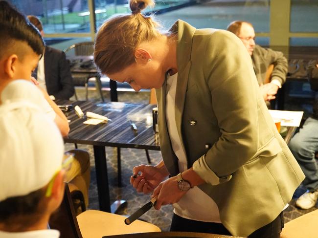 Healy signing an autograph for a young fan. Picture: Matthew Chia