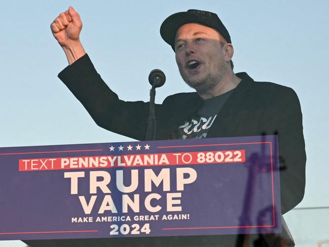 (FILES) Tesla CEO Elon Musk (R) speaks on stage as he joins former US President and Republican presidential candidate Donald Trump during a campaign rally at site of his first assassination attempt in Butler, Pennsylvania on October 5, 2024. Elon Musk, the world's richest man, is positioned to have sweeping powers in the second Trump administration as a deputy tasked with restructuring government operations using his aggressive approach to business. The next chapter in the life of the South African-born tycoon comes after he delivered unprecedented support for Trump's campaign, coming out a huge winner in his first deep dive into politics. (Photo by Jim WATSON / AFP)