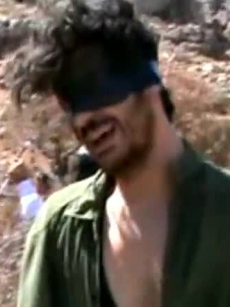 Austin Tice, 31-years-old, blindfolded with men believed to be his captors at an undisclosed location in Syria in 2012.