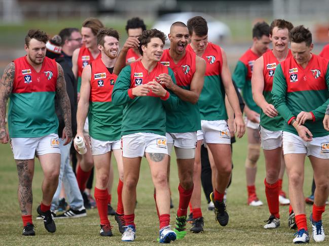 MPNFL Division 1: Mt Eliza v Frankston Pines.Jubilant Frankston Pines players including #21 Daniel John giving team mate #4 Tom McDermott a congratulatory hug, leave the ground after defeating Mount Eliza. Picture: Jason SammonSaturday 14 April 2018