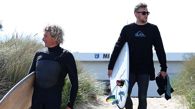 Adelaide’s Hugh Greenwood, right, heads out for a surf. Picture: Sam Rosewarne