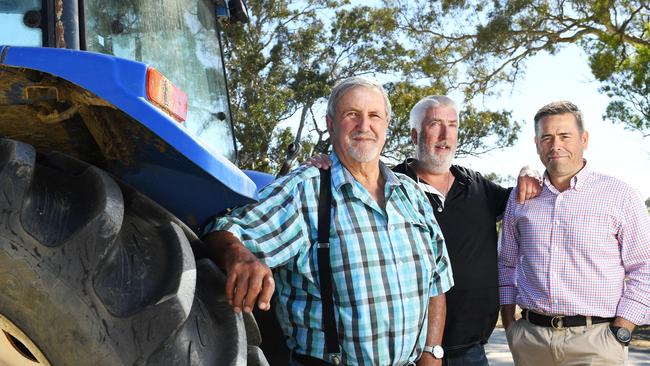 Racing legend and burns victim John Glatz with his rescuers police officer Joe McDonald and Adam Stone pictured on John’s recently rebuilt Woodside property. Picture: Tricia Watkinson