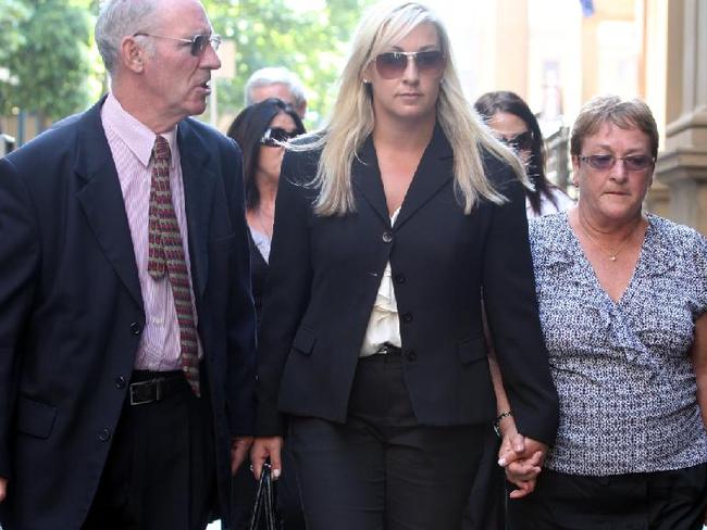 Keli Lane (centre) with her parents during her murder trial which resulted in an 18 year sentence for killing her newborn daughter.