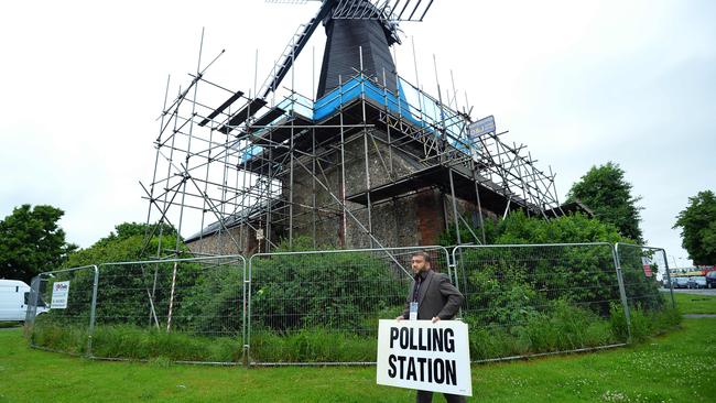 Presiding officer Ahmed Z. Jamee prepares to open the polling station at West Blatchington Windmill near Brighton, southern England yesterday.