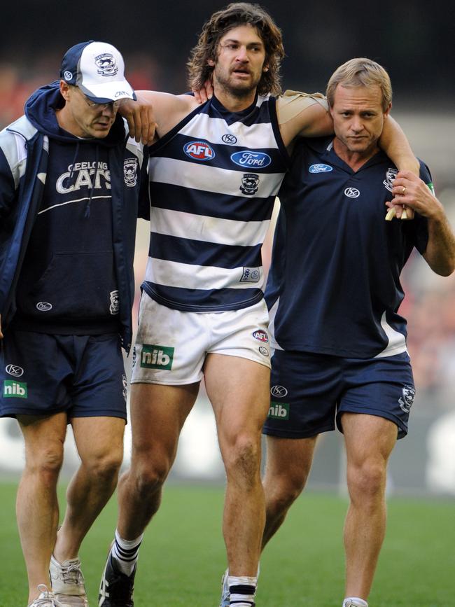 Geelong’s Max Rooke is helped off the ground after a head knock.