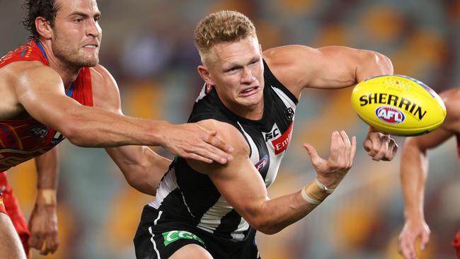 Adam Treloar dishes out a handball. Picture: Michael Klein