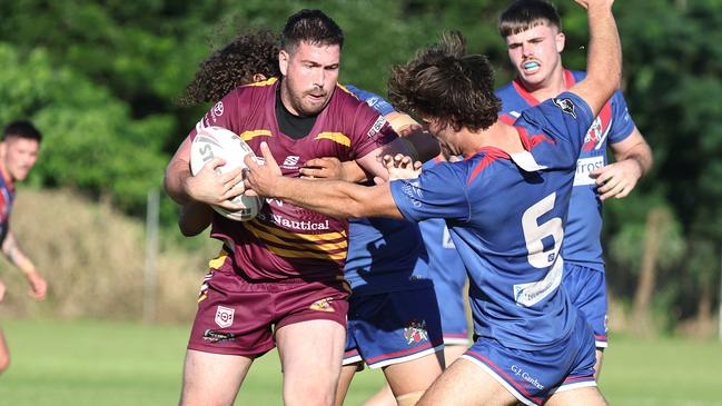 Suburbs' Jason Chapman palms away Knights' William England in the Far North Queensland Rugby League (FNQRL) match between Southern Suburbs and the Ivanhoe Knights, held at Alley Park, Gordonvale. Picture: Brendan Radke