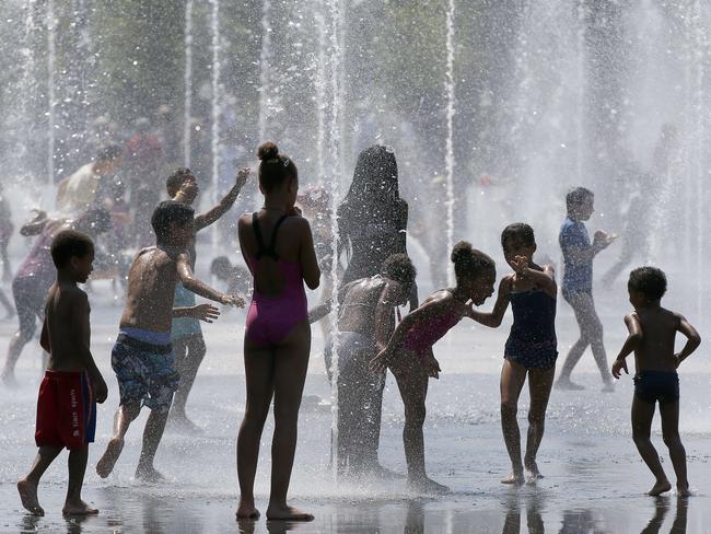 Children play in the water of a fountain on a hot summer day in Nice, south-eastern France. Pic: AFP PHOTO / VALERY HACHE