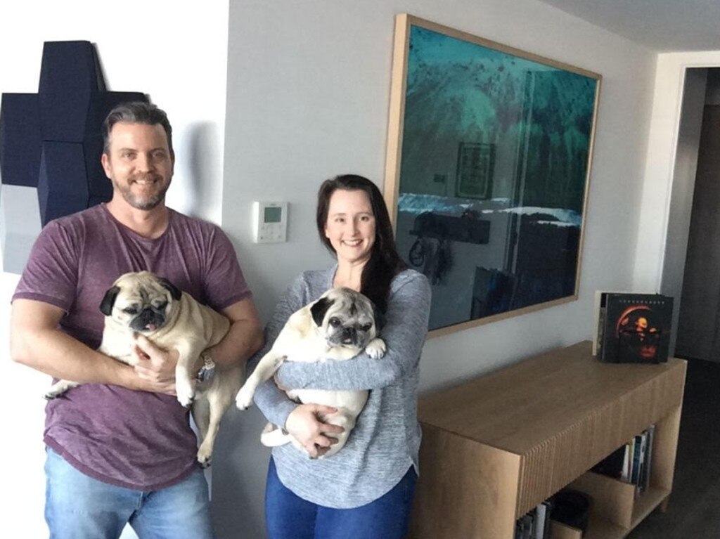 Nic and Matt Toohey and their pugs, Simba and Bosley.