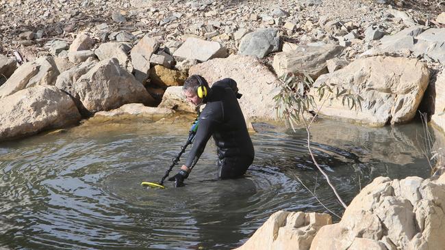 A police diver searches part of the Hutt River, north of Clare, for the gun that killed Robert Atkins. Picture NCA NewsWire / Emma Brasier.