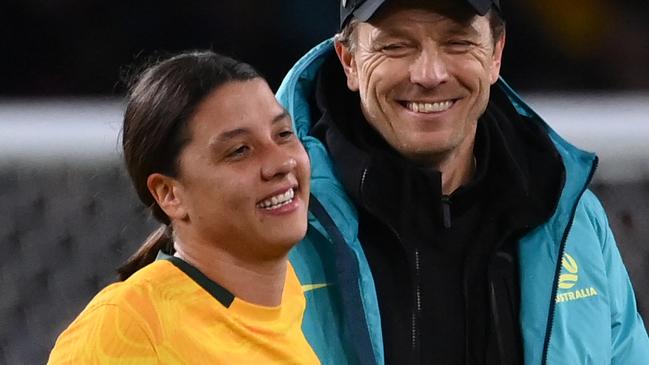 Australia's coach Tony Gustavsson (R) greets Australia's forward #20 Sam Kerr at the end of the Australia and New Zealand 2023 Women's World Cup round of 16 football match between Australia and Denmark at Stadium Australia in Sydney on August 7, 2023. (Photo by FRANCK FIFE / AFP)