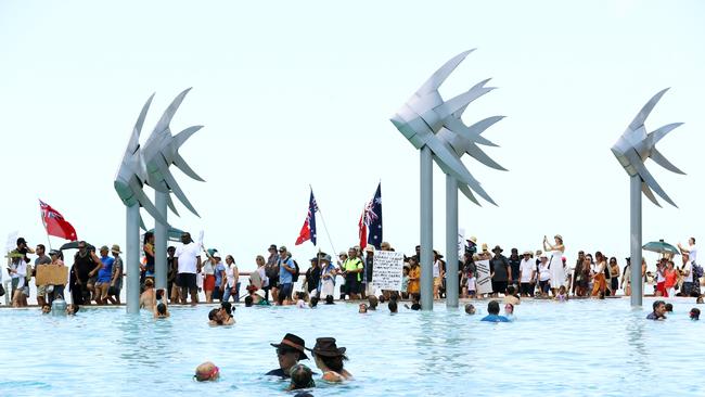 The iconic Esplanade Lagoon woven fish set the scene for thousands of passing protesters in Cairns. Picture: Brendan Radke