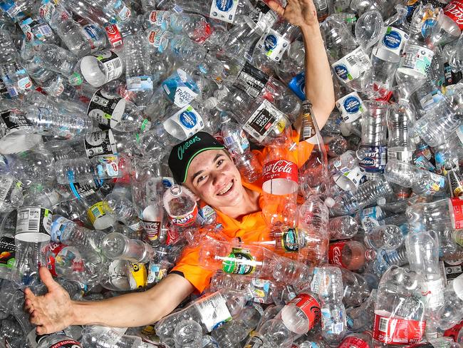 Counter and sorter for Containers for Change depot in Coorparoo, Sabastian Bailey in a sea of recycled plastic bottles as  Queenslanders are missing out on $100m a year by throwing away containers instead of cashing them in.  Picture: Zak Simmonds