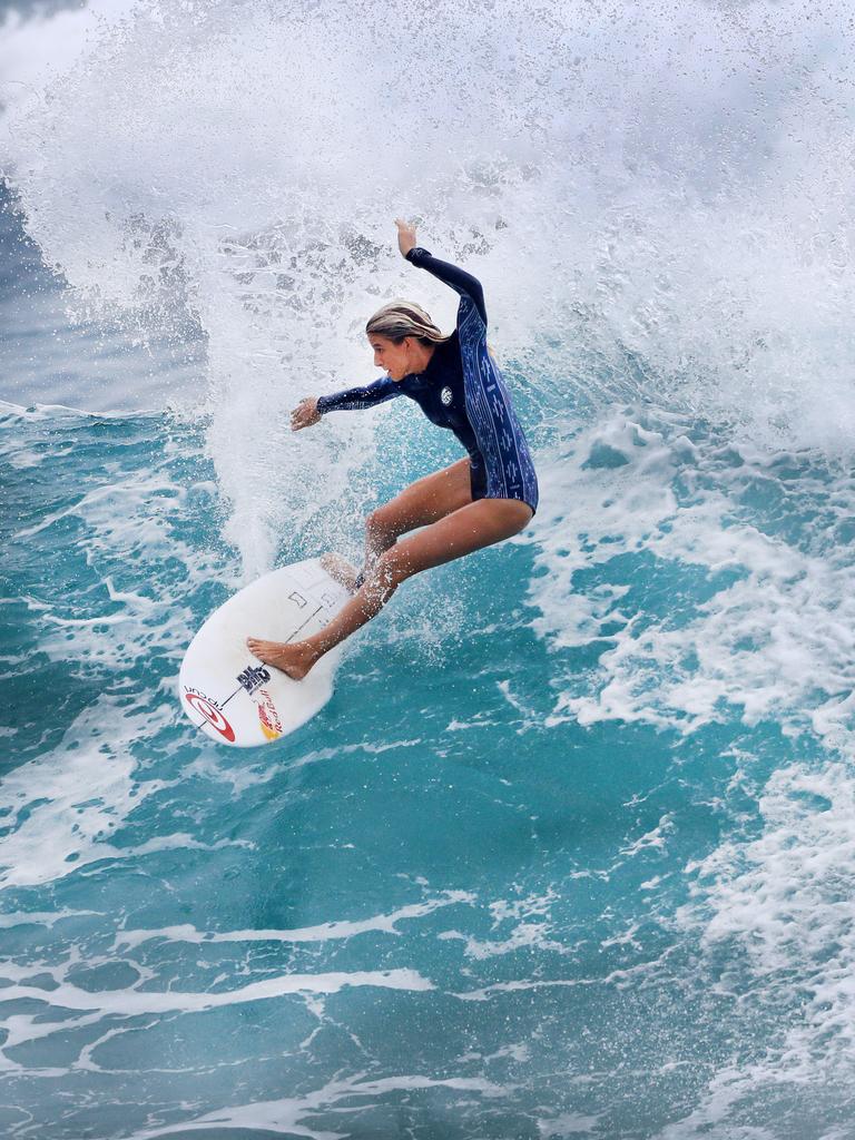 Australian junior female surfer Molly Picklum takes off on a wave at Burleigh point as wet weather descended over the Gold Coast. Photo: Scott Powick NEWSCORP