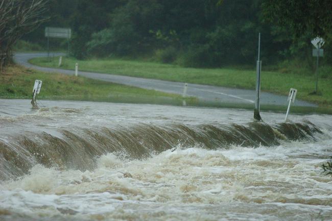 Gold Coast, June 30, 2005. Floodwaters at Bird St causeway on the upper reaches of the Coomera River at Maudsland on Queensland’s Gold Coast today. Rescuers are searching for a man and a woman believed to have been swept from this causeway. It is thought the couple were here when they made a distress call and it is feared they have been swept into the Coomera River. Widespread flooding has hit the Gold Coast area, normally known for its sunshine and sandy beaches. (AAP Image/Tony Phillips)