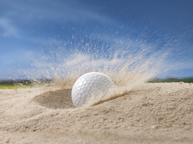 golf ball fell on sand trap causing the sand flying