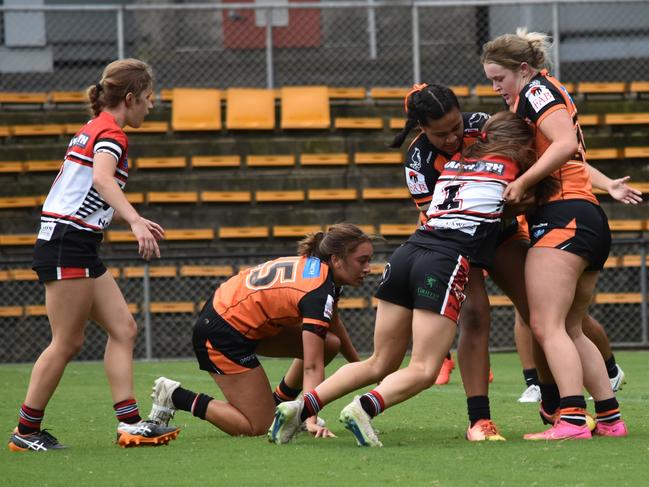 Timeka Collins is wrapped up by the Tigers defence. Picture: Sean Teuma