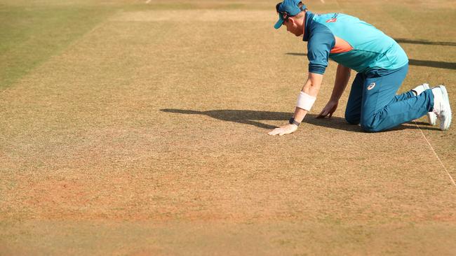 Steve Smith checks out the pitch.