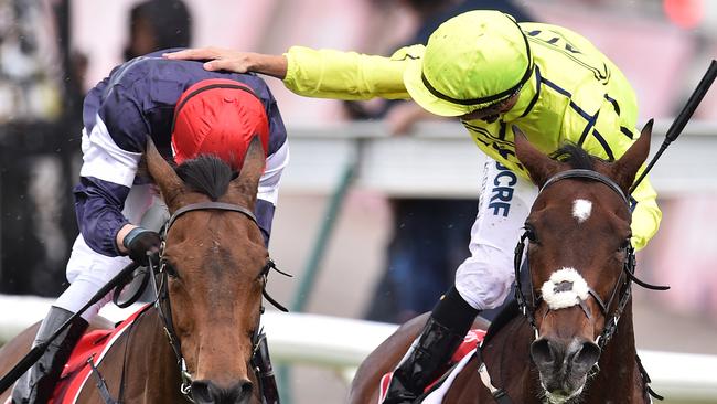 Kerrin McEvoy wins the 2016 Cup on Almandin, but Joao Moreira (right), riding Heartbreak City, was quick to congratulate the winner. Picture: AAP