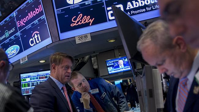 Traders work on the floor of the New York Stock Exchange