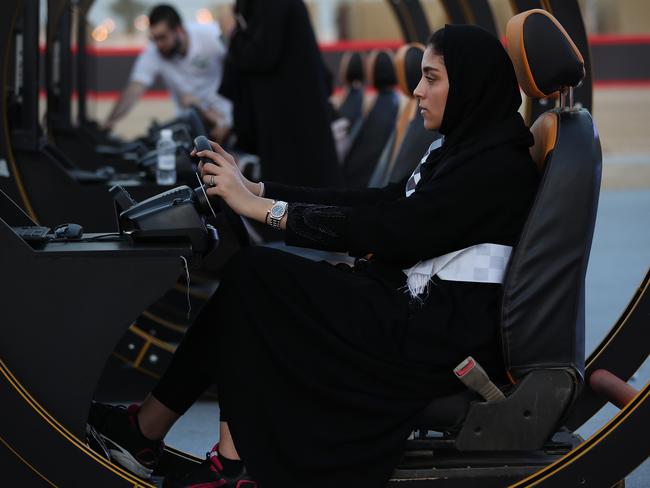 A young woman in Jeddah tries out a driving simulator at an outdoor educational driving event for women on June 23, 2018. Picture: Sean Gallup/Getty Images