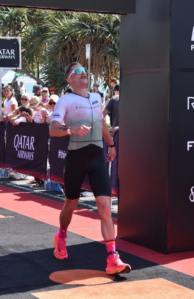 Athletes crossing the finish line at the Sunshine Coast Ironman 70.3 2023.