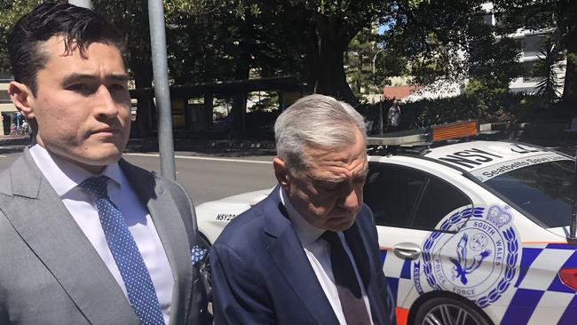 Former TV newsreader and presenter John Mangos (right), 66, from Seaforth, with his solicitor Bryan Wrench, leaving Manly Local Court where he was convicted of mid-range drink driving at 1.30pm on a Thursday. Picture: Jim O'Rourke