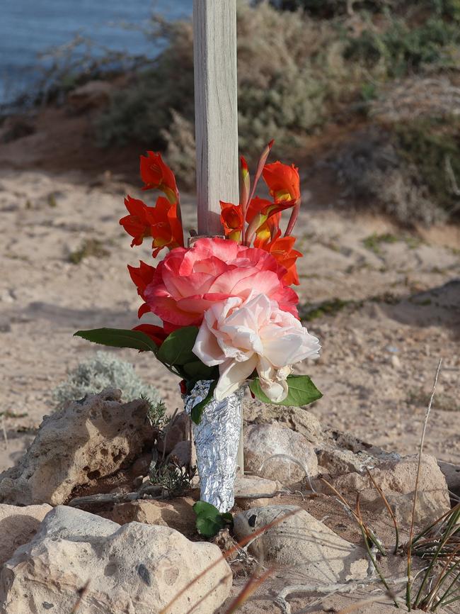 Flowers were laid at the beach where Mr Baccanello was attacked. Picture: Riley Walter
