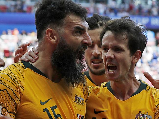 SoccerooÕs Mile Jedinak celebrates scoring a goal with team mates Andrew Nabbout and Robbie Kruse in the Socceroos opening 2018 World Cup match against France at Kazan Arena in Russia. Picture: Toby Zerna