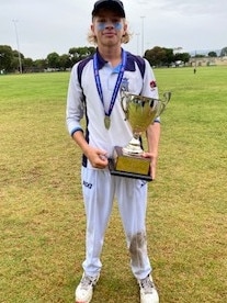 Doe holds up the premiership trophy, won by his under-16 Sturt cricket team last season. Picture: Supplied