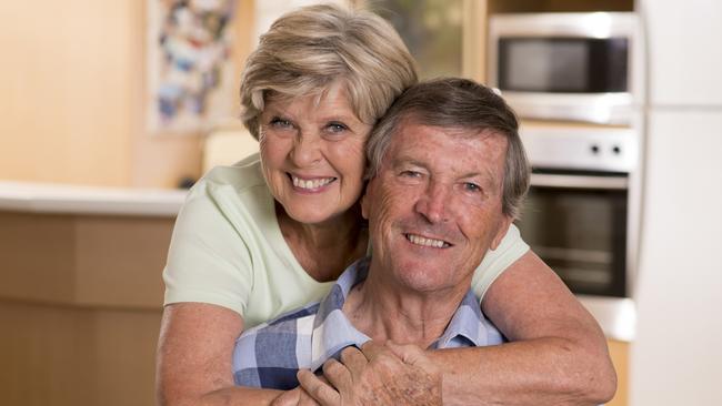 senior beautiful middle age couple around 70 years old smiling happy together at home kitchen looking sweet in lifetime husband and wife enjoying life and love concept; retirees, seniors generic